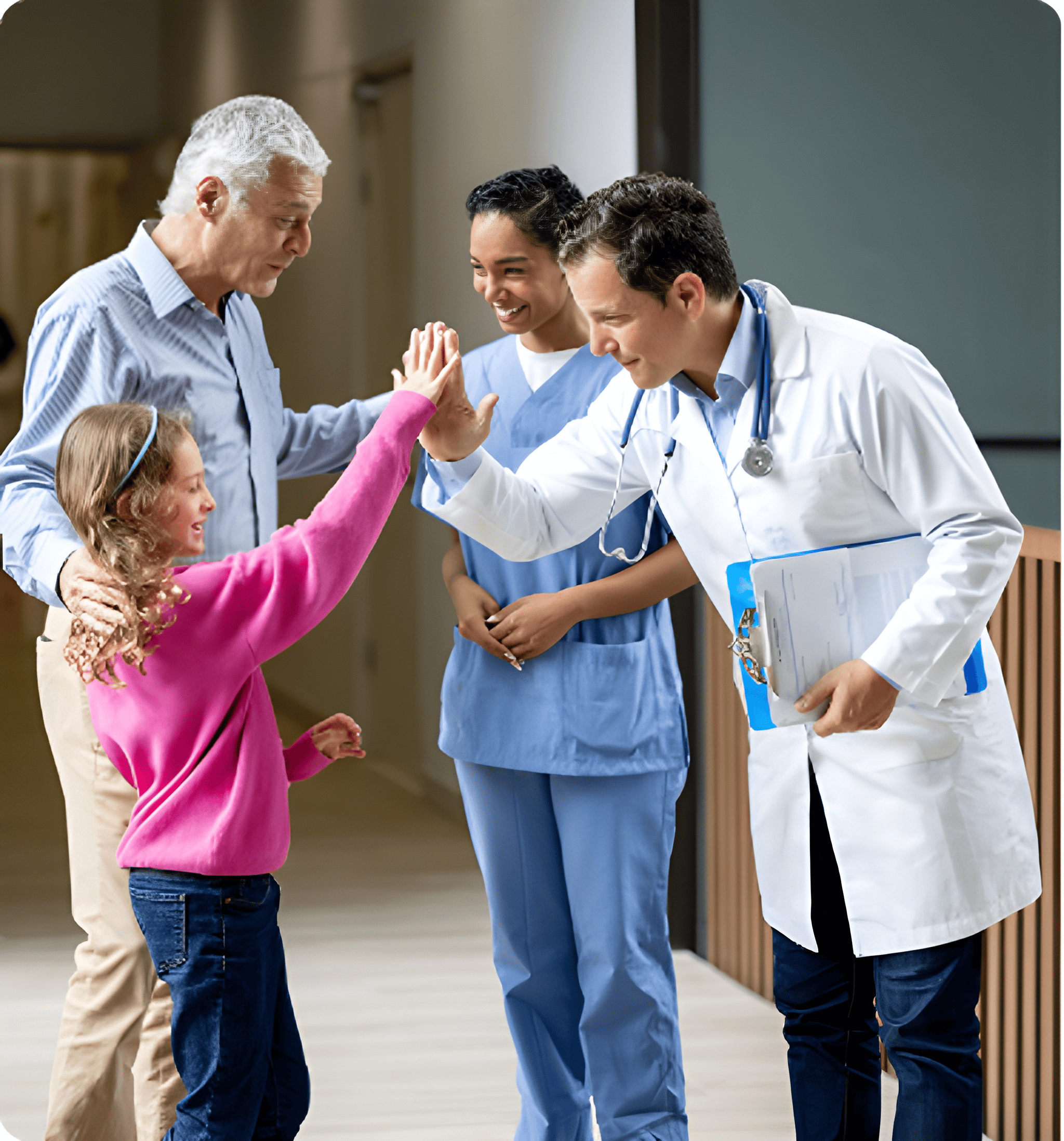 Doctor high-fives young girl at hospital.